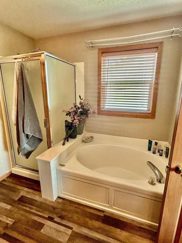 7263 Falmouth Curv, Shakopee, MN 55379 - bathroom with a bath, wood finished floors, and a shower stall