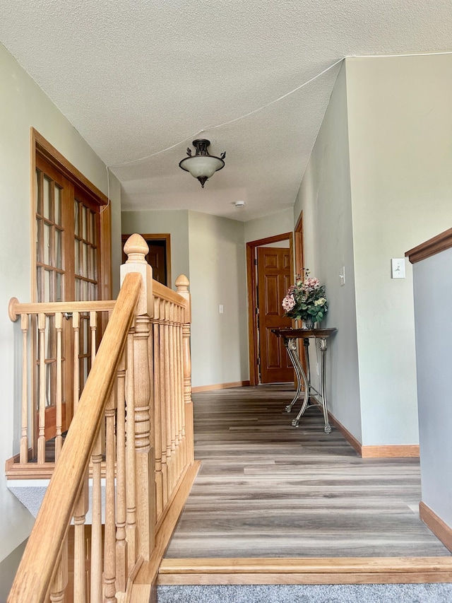 7263 Falmouth Curv, Shakopee, MN 55379 - hall with an upstairs landing, baseboards, a textured ceiling, carpet, and wood finished floors