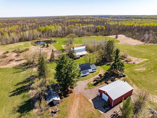 drone / aerial view of a heavily wooded area and a large body of water