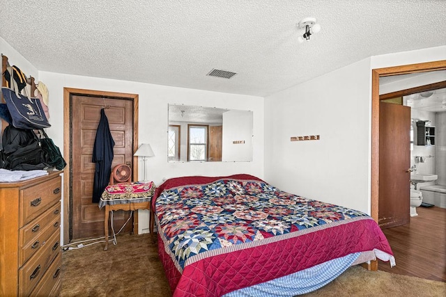 bedroom with a textured ceiling and carpet