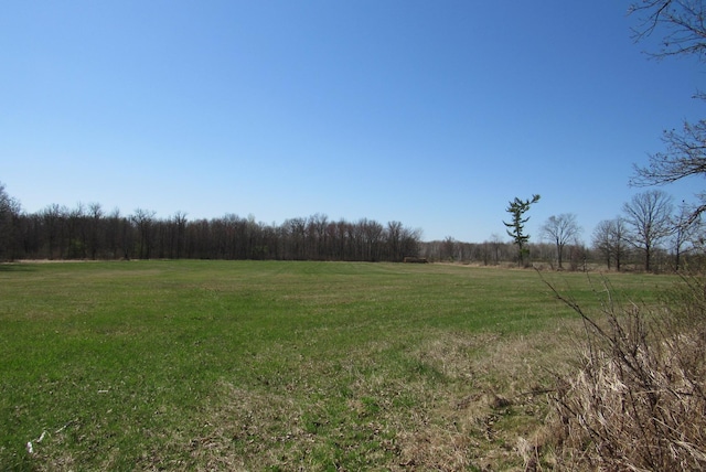 view of woods featuring a view of countryside