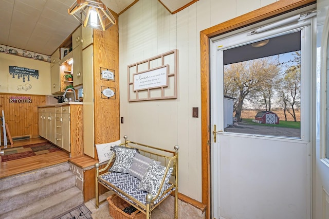 doorway featuring wood walls