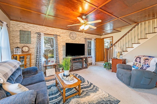 carpeted living area with wooden ceiling, a ceiling fan, and stairway