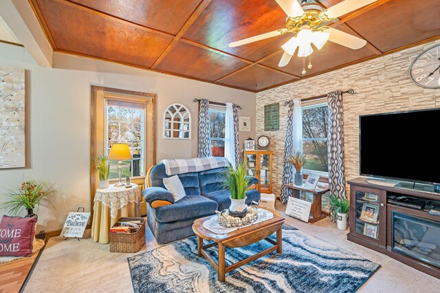 living area featuring wood ceiling, ceiling fan, and carpet