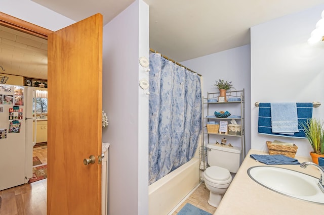 bathroom featuring toilet, shower / bath combo, and vanity