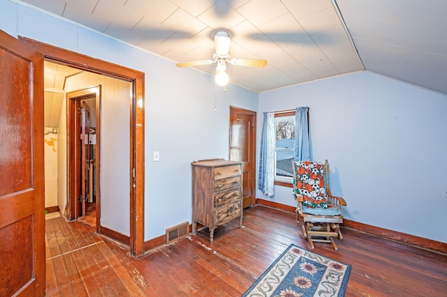 sitting room with hardwood / wood-style flooring, ceiling fan, vaulted ceiling, and baseboards