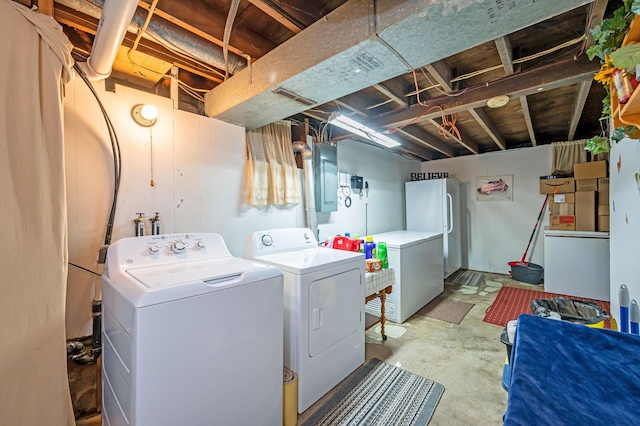 washroom featuring washing machine and clothes dryer and electric panel