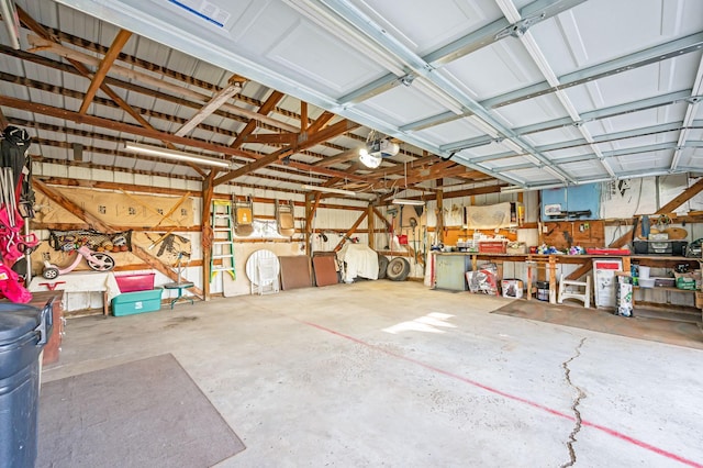 garage with a garage door opener and a workshop area
