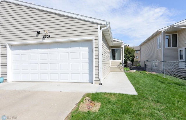 1509 28th Ave S, Fargo, ND 58103 - view of home's exterior featuring concrete driveway, a yard, fence, and an attached garage