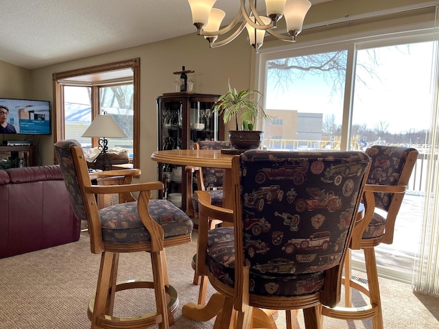 dining space with a healthy amount of sunlight, light colored carpet, and a chandelier