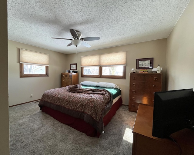 carpeted bedroom with multiple windows, ceiling fan, and a textured ceiling
