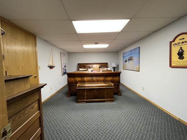 miscellaneous room with carpet, baseboards, and a drop ceiling