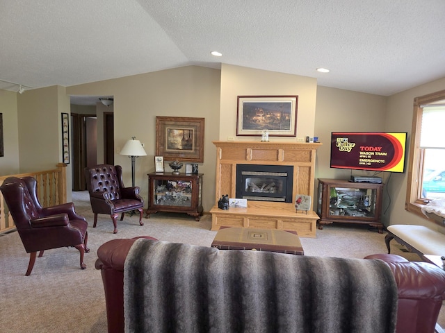1085 20th St, Windom, MN 56101 - living room featuring carpet floors, vaulted ceiling, a glass covered fireplace, a textured ceiling, and recessed lighting