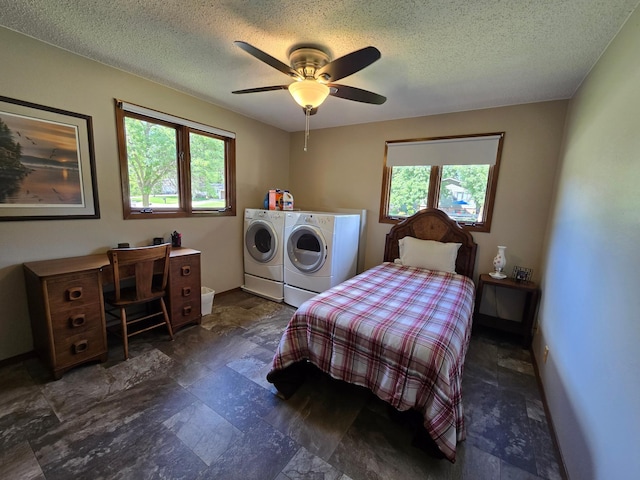 1085 20th St, Windom, MN 56101 - bedroom with independent washer and dryer, a textured ceiling, ceiling fan, and stone finish floors