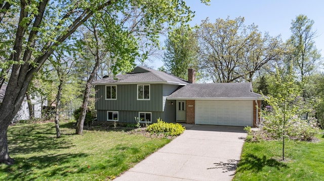 13056 Euclid Ave, Apple Valley, MN 55124 - split level home with a garage, driveway, a chimney, and a front yard