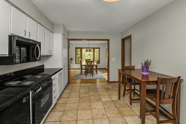 13056 Euclid Ave, Apple Valley, MN 55124 - kitchen featuring black electric range, white cabinets, light tile patterned floors, a textured ceiling, and dark countertops