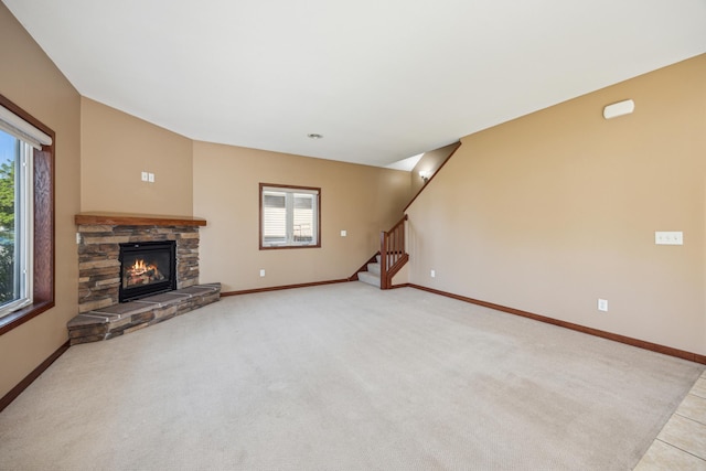 173 Cardinal Ln, Clearwater, MN 55320 - unfurnished living room with baseboards, stairway, a stone fireplace, and light carpet