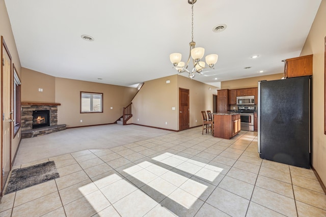 173 Cardinal Ln, Clearwater, MN 55320 - kitchen featuring stainless steel appliances, light carpet, open floor plan, brown cabinetry, and baseboards