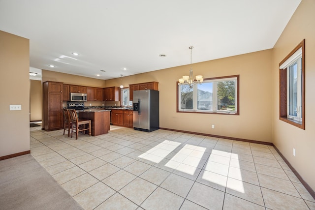 173 Cardinal Ln, Clearwater, MN 55320 - kitchen with appliances with stainless steel finishes, a chandelier, plenty of natural light, a kitchen breakfast bar, and recessed lighting