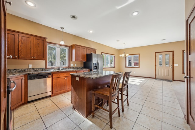 173 Cardinal Ln, Clearwater, MN 55320 - kitchen featuring stainless steel dishwasher, fridge with ice dispenser, brown cabinetry, a kitchen island, and a chandelier