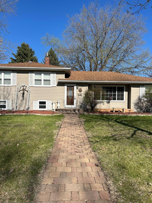 view of front of home featuring a front yard and a chimney