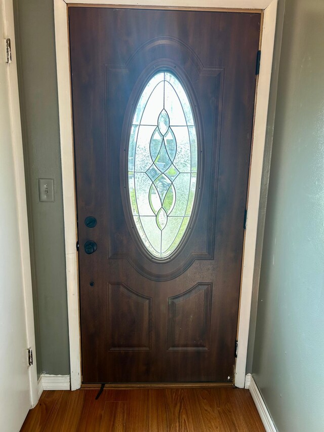 entryway featuring wood finished floors and baseboards