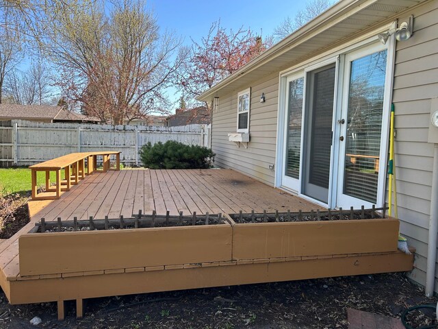 wooden deck featuring a fenced backyard