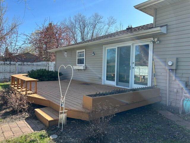 back of house with a deck and fence