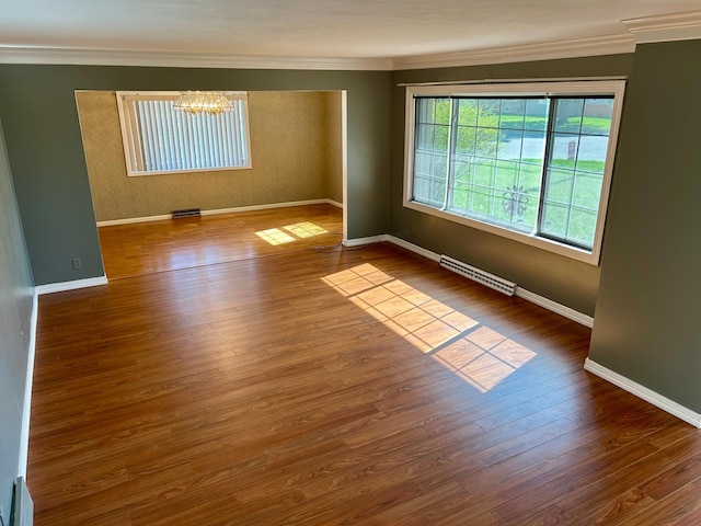 324 Maple Ave S, Thief River Falls, MN 56701 - empty room with crown molding, a chandelier, baseboards, and wood finished floors
