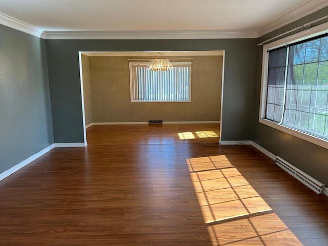 324 Maple Ave S, Thief River Falls, MN 56701 - spare room featuring a chandelier, crown molding, baseboards, and dark wood-style floors