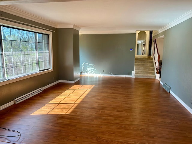 324 Maple Ave S, Thief River Falls, MN 56701 - spare room featuring ornamental molding, stairway, wood finished floors, and baseboards