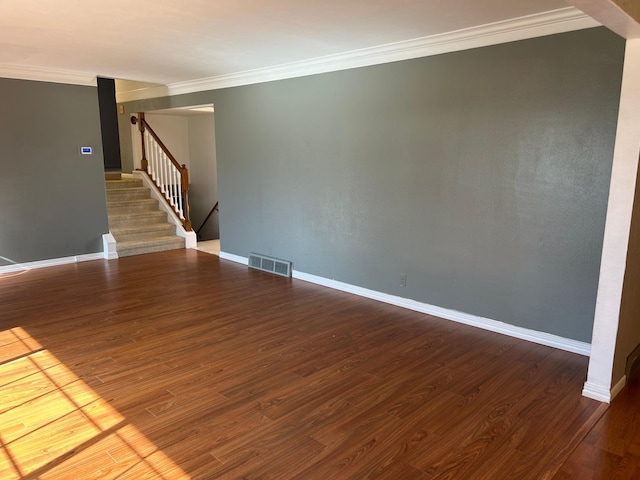 324 Maple Ave S, Thief River Falls, MN 56701 - spare room with stairs, ornamental molding, wood finished floors, and baseboards