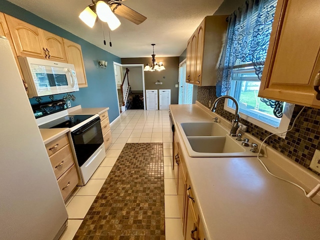 324 Maple Ave S, Thief River Falls, MN 56701 - kitchen featuring electric range, white microwave, decorative backsplash, a sink, and a chandelier