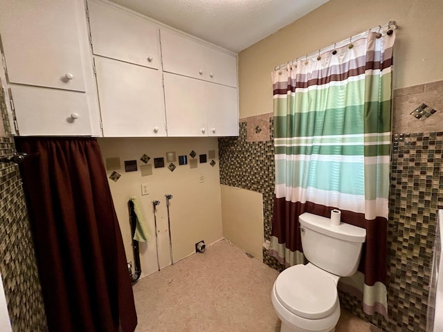 324 Maple Ave S, Thief River Falls, MN 56701 - full bath with toilet, tile walls, wainscoting, and a shower with shower curtain