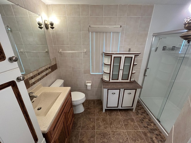 324 Maple Ave S, Thief River Falls, MN 56701 - full bath featuring tile walls, vanity, a shower stall, and toilet