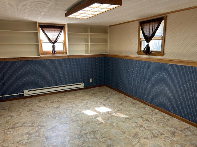 324 Maple Ave S, Thief River Falls, MN 56701 - spare room with a baseboard heating unit, wallpapered walls, baseboards, and stone finish flooring