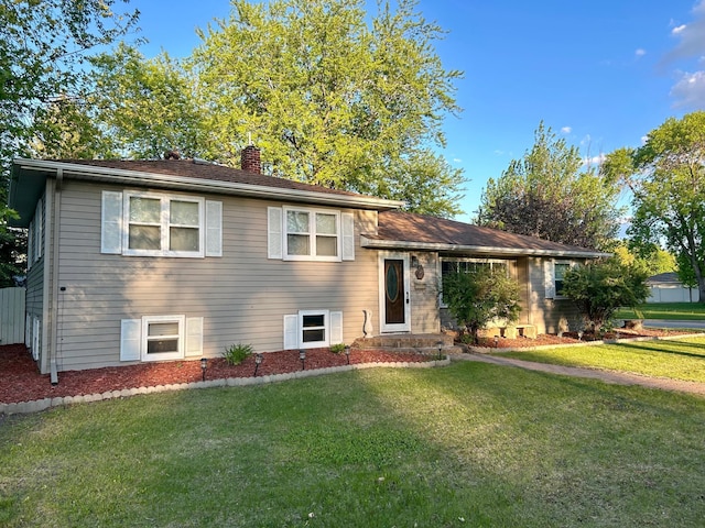 324 Maple Ave S, Thief River Falls, MN 56701 - split level home featuring a chimney and a front lawn