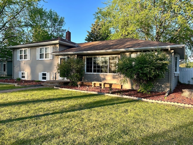 324 Maple Ave S, Thief River Falls, MN 56701 - split level home featuring a chimney and a front lawn