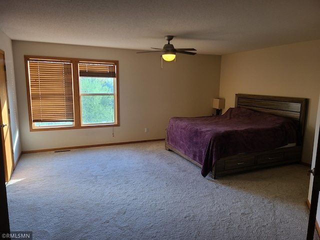 carpeted bedroom featuring baseboards and ceiling fan