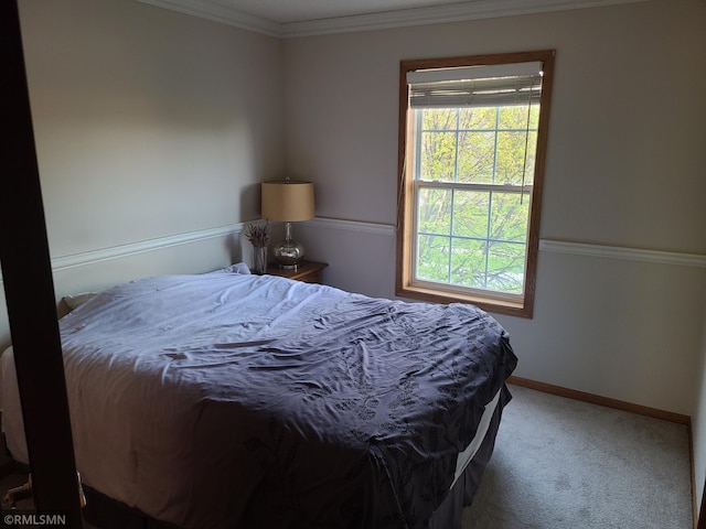 bedroom with multiple windows, carpet floors, ornamental molding, and baseboards