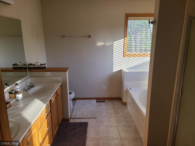 full bath with a garden tub, double vanity, toilet, tile patterned flooring, and baseboards