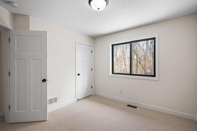 unfurnished bedroom with carpet, baseboards, and a closet