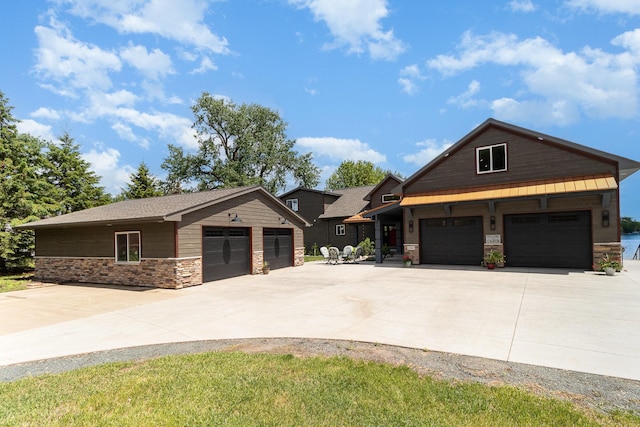 27667 Bay Shore Dr NW, Isanti, MN 55040 - view of front of home featuring stone siding, a garage, and driveway