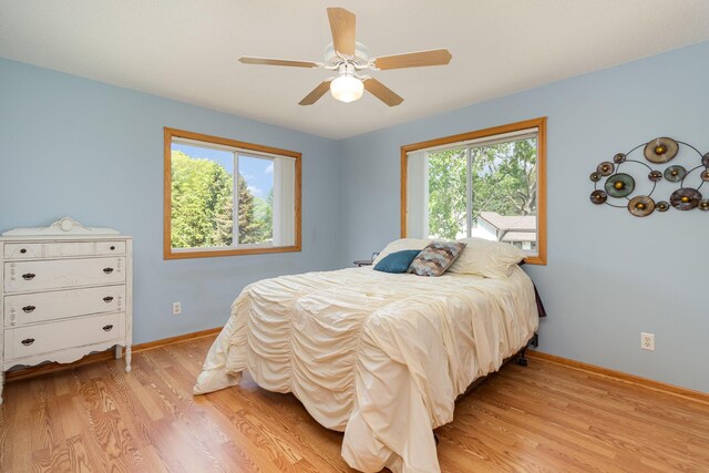 27667 Bay Shore Dr NW, Isanti, MN 55040 - bedroom featuring light wood-type flooring, baseboards, and a ceiling fan