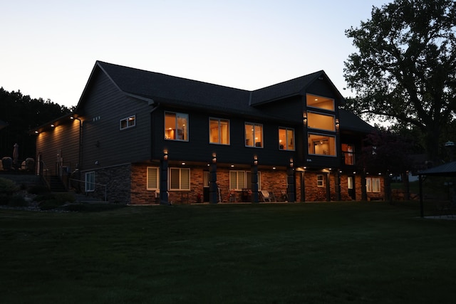 27667 Bay Shore Dr NW, Isanti, MN 55040 - back of property featuring stone siding, a lawn, and stairs