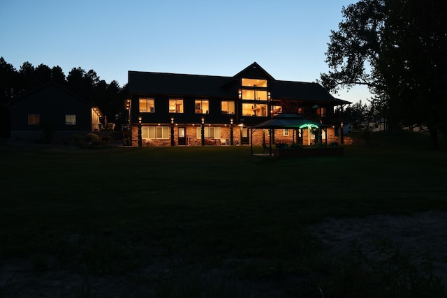 27667 Bay Shore Dr NW, Isanti, MN 55040 - rear view of property with a yard and stone siding