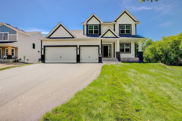8683 Peony Ln N, Maple Grove, MN 55311 - craftsman house with asphalt driveway, a garage, a front lawn, covered porch, and board and batten siding