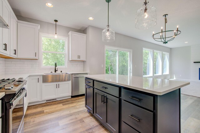 8683 Peony Ln N, Maple Grove, MN 55311 - kitchen featuring stainless steel appliances, a sink, plenty of natural light, white cabinetry, and recessed lighting