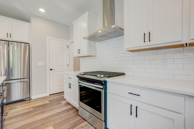 8683 Peony Ln N, Maple Grove, MN 55311 - kitchen with stainless steel appliances, wall chimney range hood, light countertops, recessed lighting, and light wood-style flooring