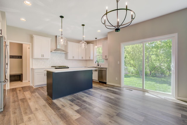 8683 Peony Ln N, Maple Grove, MN 55311 - kitchen featuring wall chimney exhaust hood, appliances with stainless steel finishes, light countertops, a sink, and backsplash